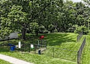Thumbnail 21 of 39 - A green fenced area with a red ball and a sign.