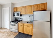 Thumbnail 15 of 39 - A kitchen with a refrigerator, stove, and oven.