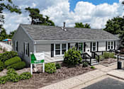 Thumbnail 32 of 39 - A house with a sign that says Rolling Pines.