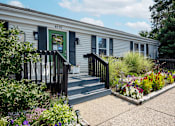 Thumbnail 28 of 29 - the exterior of rolling pines office with a garden in front of it