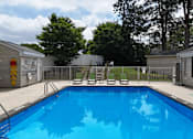Thumbnail 26 of 39 - A small pool surrounded by a fence and chairs.