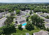 Thumbnail 38 of 39 - A bird's eye view of an apartment complex with a swimming pool.