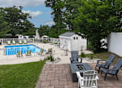 Thumbnail 25 of 39 - A backyard with a pool, patio furniture, and a white fence.
