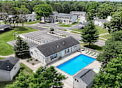 Thumbnail 33 of 39 - A large building with a pool in front of it.