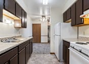 Thumbnail 10 of 22 - a kitchen with a white stove and a refrigerator