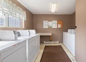 Thumbnail 15 of 22 - resident laundry room with washes and dryers