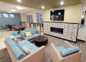 Thumbnail 11 of 14 - A living room with a fireplace and a television.