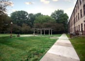 Thumbnail 11 of 22 - a grassy picnic area with a building