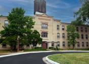Thumbnail 1 of 22 - a large brick building with a silo on top