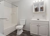 Thumbnail 10 of 25 - apartment bathroom with a toilet sink and shower