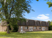 Thumbnail 21 of 25 - an brick building under a shade tree