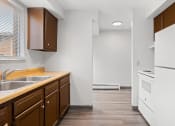 Thumbnail 6 of 25 - a kitchen with a sink and a stove and a refrigerator