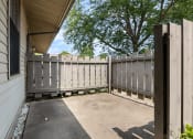 Thumbnail 16 of 25 - a white fence on the side of a house with a building