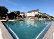 Thumbnail 26 of 30 - a large swimming pool with River Ranch Apartments in the background