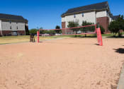 Thumbnail 22 of 30 - a sand volleyball court in front of a house