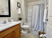 Thumbnail 7 of 30 - full bathroom with tub and under the sink storage