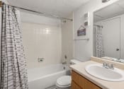 Thumbnail 10 of 23 - a bathroom with a sink and a shower and a toilet