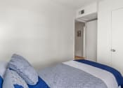 Thumbnail 8 of 23 - a bedroom with a bed and a door to a hallway