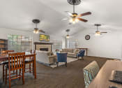 Thumbnail 11 of 23 - a living room and dining room with couches and a table