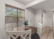 Thumbnail 1 of 23 - a dining room with a table and chairs and a window