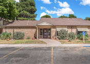Thumbnail 23 of 23 - the front of a brick building with a sidewalk and a parking lot