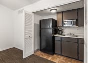 Thumbnail 7 of 23 - a kitchen with a refrigerator microwave and sink