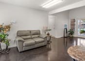 Thumbnail 16 of 23 - a living room with a couch and a table