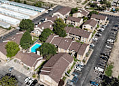 Thumbnail 29 of 30 - A bird's eye view of a residential area with houses and parked cars.