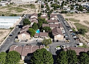 Thumbnail 30 of 30 - A bird's eye view of a residential area with houses and parked cars.