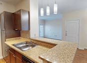 Thumbnail 7 of 32 - A kitchen with a sink and cabinets.