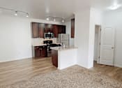 Thumbnail 2 of 32 - A kitchen with wooden cabinets and a white island.