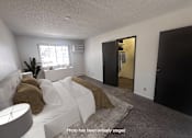Thumbnail 5 of 20 - A living room with a white couch and a brown pillow.