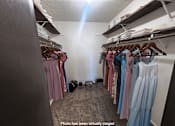Thumbnail 8 of 20 - A closet full of clothes and a sign on the floor.