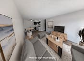 Thumbnail 3 of 20 - A living room with a grey couch and a painting on the wall.
