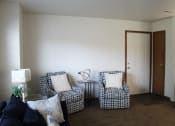 Thumbnail 10 of 35 - a living room with two chairs and a table