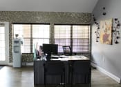 Thumbnail 27 of 35 - apartment leasing office with a desk and chairs