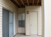 Thumbnail 28 of 35 - a front porch with a white door and a window