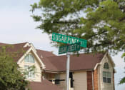Thumbnail 34 of 35 - a street sign in front of a house