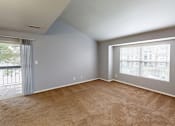 Thumbnail 13 of 30 - A room with a carpeted floor and a window with blinds.