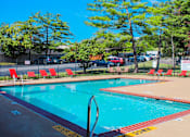 Thumbnail 28 of 30 - A pool with a diving board and a yellow caution tape on the ground.
