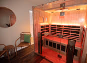 Thumbnail 22 of 39 - a sauna in a room with a glass door