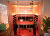 Thumbnail 23 of 39 - an infrared sauna is shown in a room with a plant