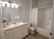 Thumbnail 13 of 39 - a bathroom with a sink and a toilet and a shower