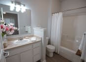 Thumbnail 15 of 39 - a bathroom with a sink toilet and a mirror