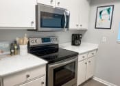 Thumbnail 4 of 39 - kitchen with microwave and oven at shoreline landing apartments