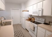 Thumbnail 5 of 39 - a kitchen with white appliances and white cabinets