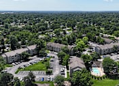 Thumbnail 29 of 29 - A bird's eye view of a residential area with houses, cars, and a pool.