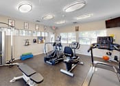 Thumbnail 14 of 29 - A gym with a variety of equipment including treadmills, exercise bikes, and weight benches.