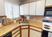 Thumbnail 7 of 29 - A kitchen with wooden cabinets and a sign that says EAT