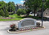 Thumbnail 21 of 29 - A sign for Southpointe Apartment Homes is in front of a building.